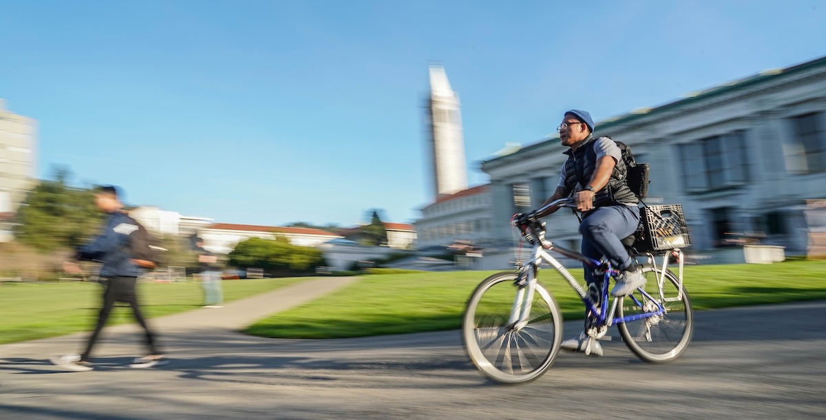 A cyclist is photographed while riding by Doe Library on Jan. 22, 2019